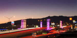 ground view of El Paso, TX, skyline near I-10 at twilight, showcasing LED-lit sculptures