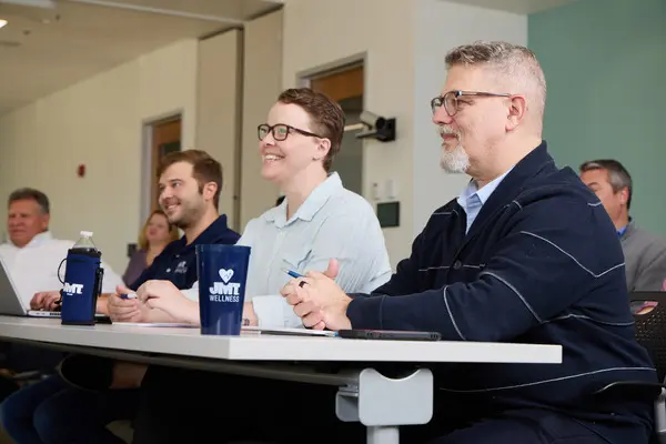 People sitting at a table looking forward
