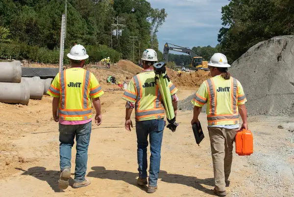Three workers walking on job site