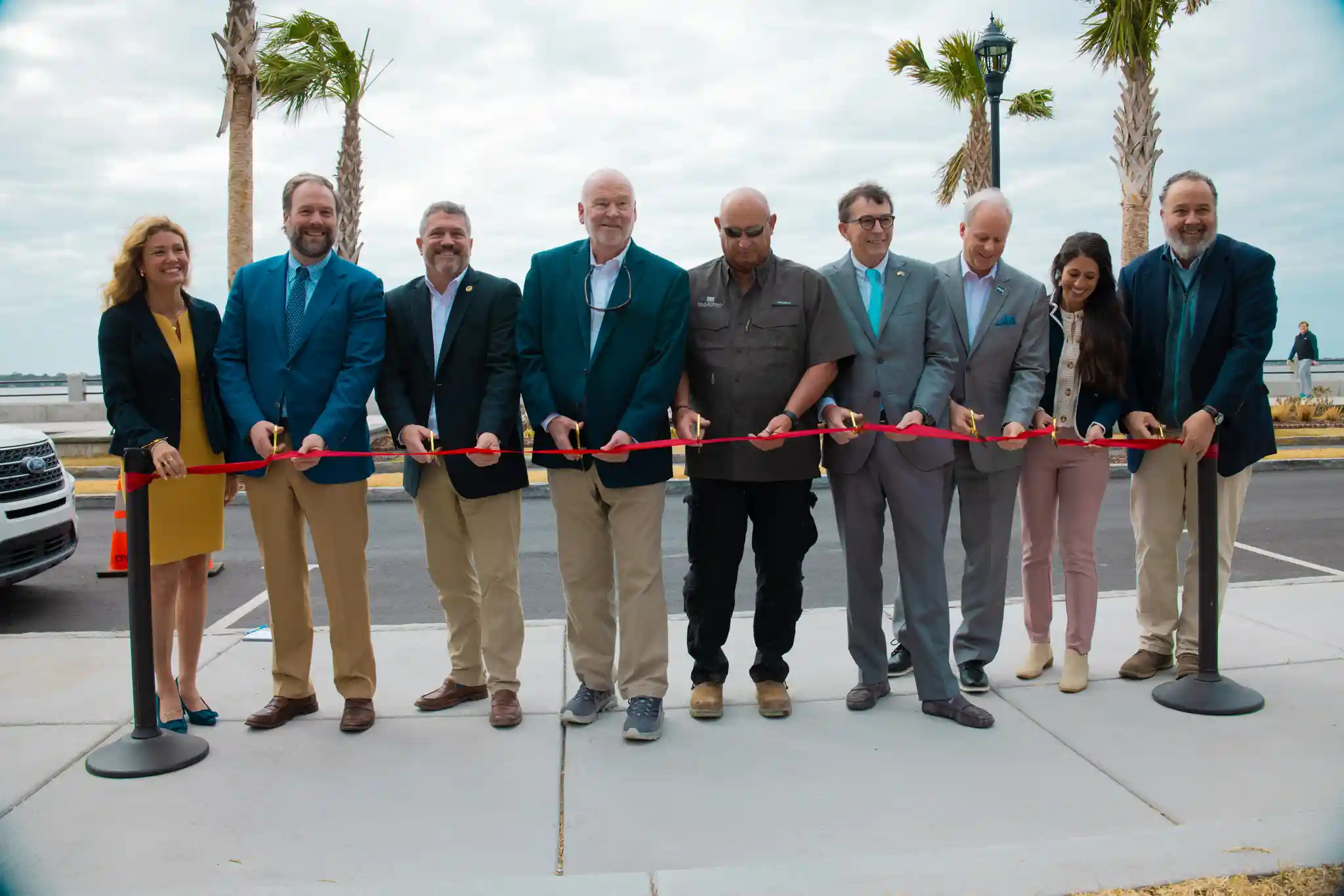 Group gathered for ribbon cutting at low battery seawall